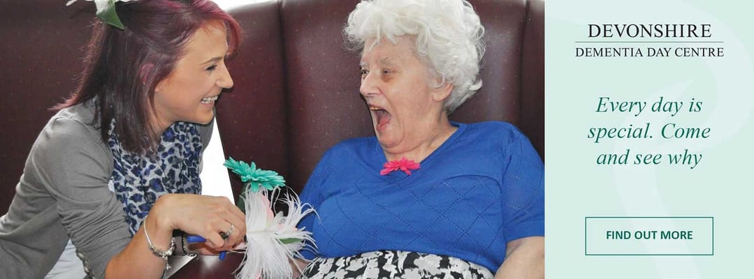 Staff member engaging with a resident in a cozy setting