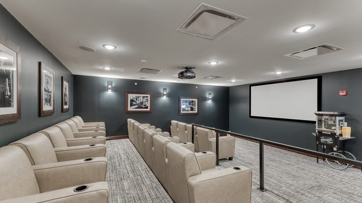 Cozy theater room with plush seating and a projector
