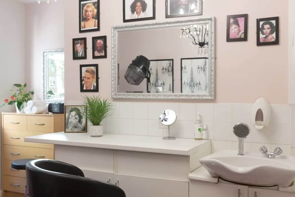 Interior view of a salon with vintage photos on the wall