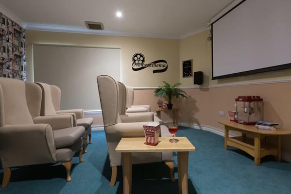 Interior of a cozy movie room with seating and snacks