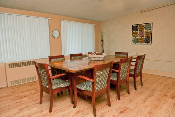 Bright dining room with large wooden table and chairs