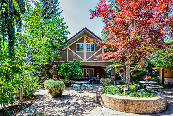 Exterior view of a senior living facility with landscaping