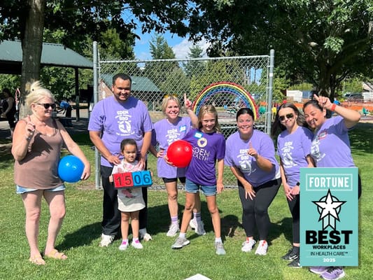 Residents and staff enjoying an outdoor activity with colorful balls