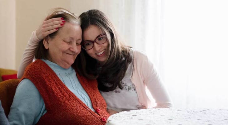 An older woman sharing a joyful moment with a young woman