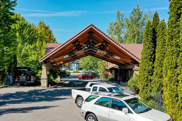 Covered entrance with vehicles in the parking area