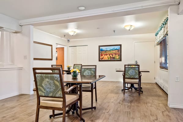 Common area with dining tables and artwork