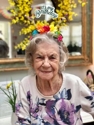 Resident celebrating a birthday with colorful decorations