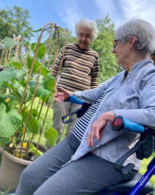 Two residents enjoying a garden space together