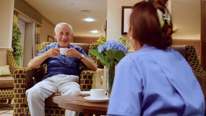 Resident enjoying tea in a common area