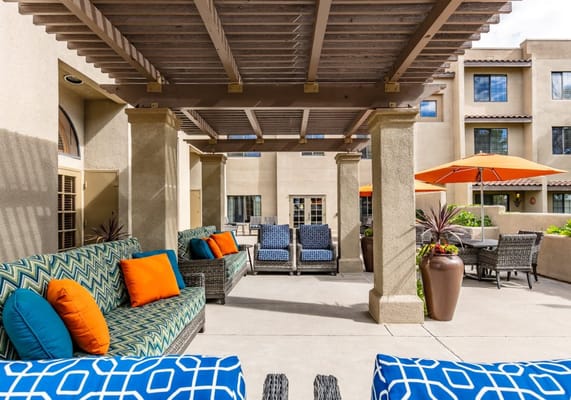 Outdoor seating area with colorful cushions and umbrellas