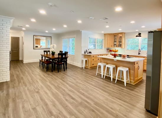 Bright interior common area with dining table and kitchen