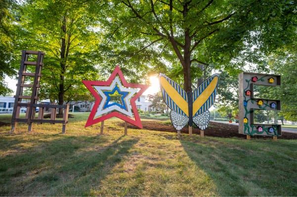 Colorful outdoor letters spelling 'LOVE' in a garden