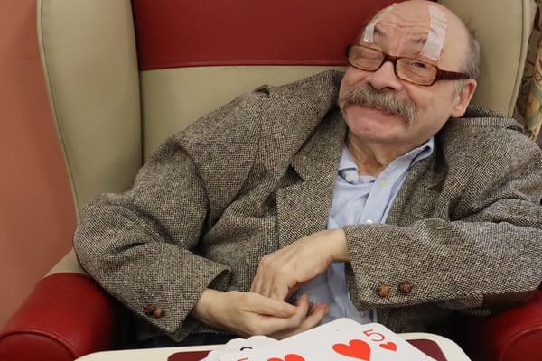 Resident enjoying a game of cards in a cozy armchair