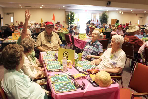 Residents enjoying a lively game of bingo in a common area