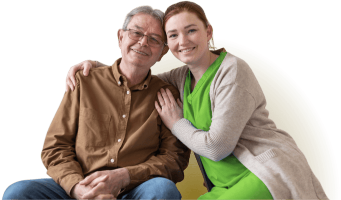 A senior man and caregiver smiling together