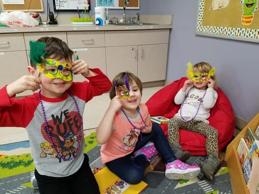 Children wearing colorful masks during an activity