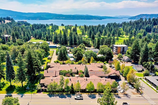 Aerial view of the assisted living facility surrounded by trees and water