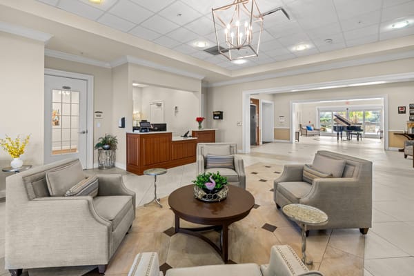 Common area lounge with comfortable seating and piano