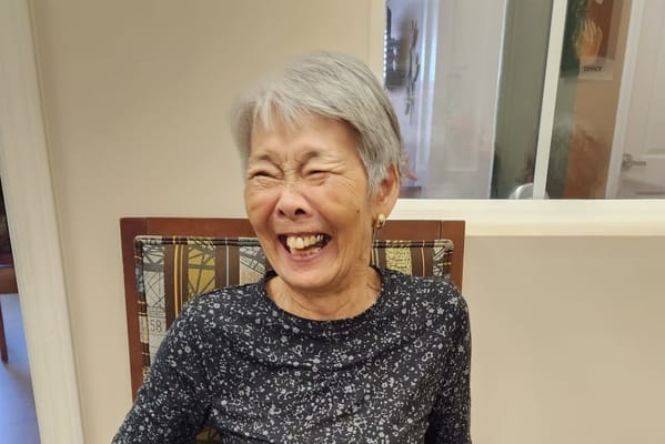 Senior woman laughing in a common area