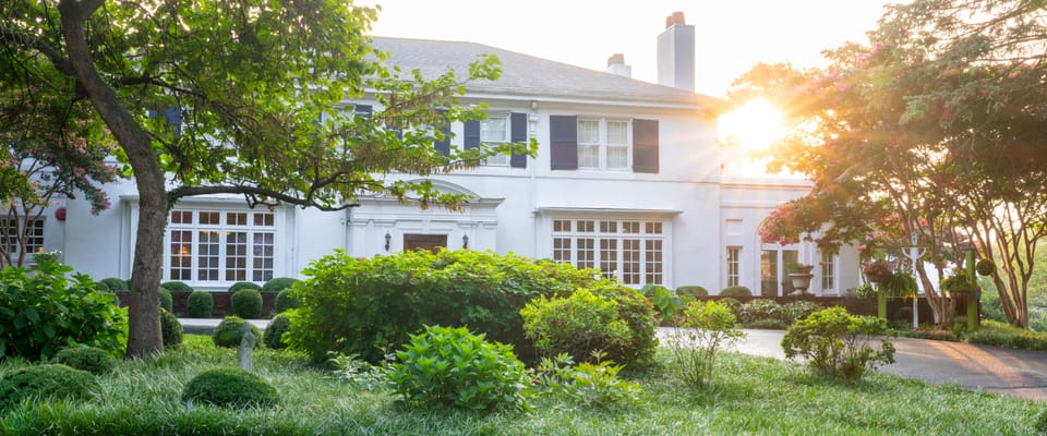 Exterior view of a senior living facility with gardens