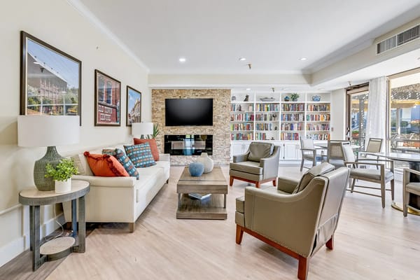 Bright common area with comfortable seating and bookshelves