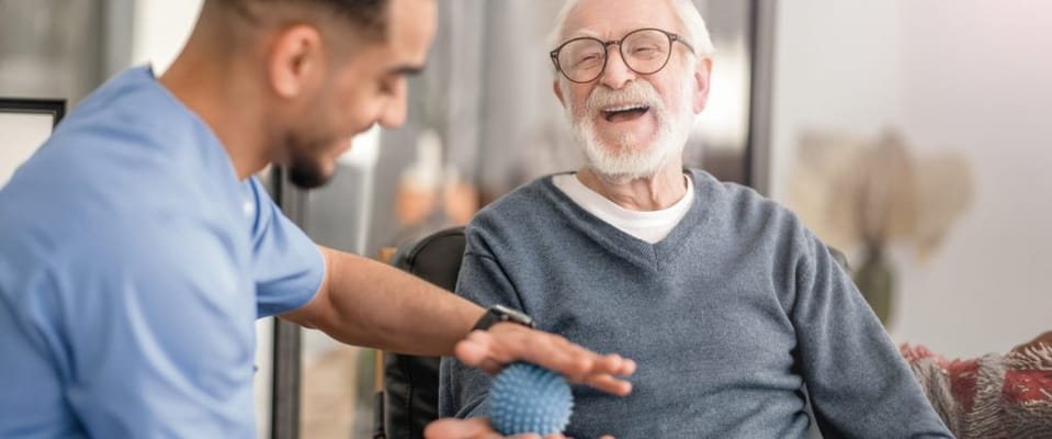 Staff member interacting with a smiling resident