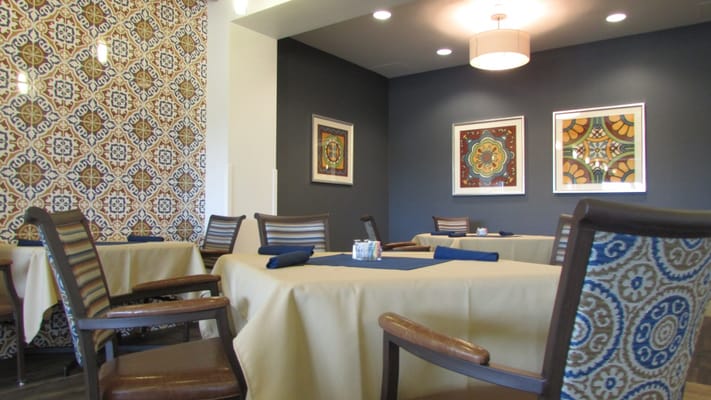 Bright dining room with patterned decor and tables