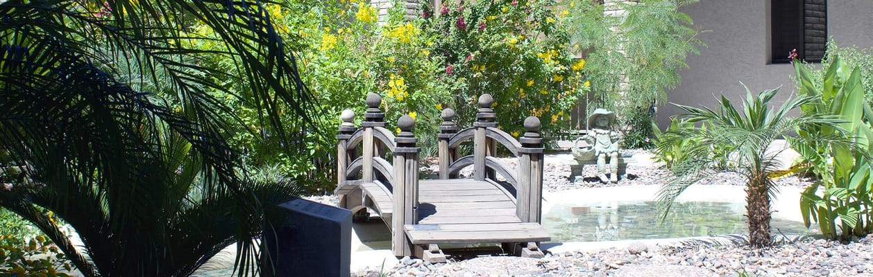 A serene garden bridge surrounded by colorful plants