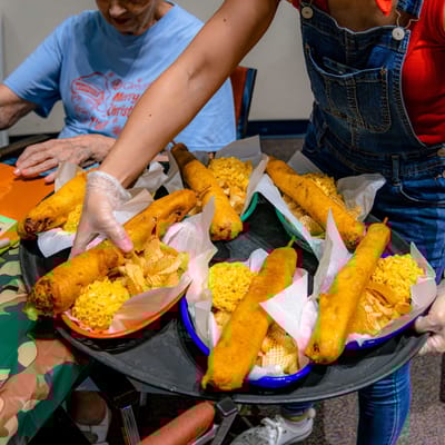 A staff member serving food to residents