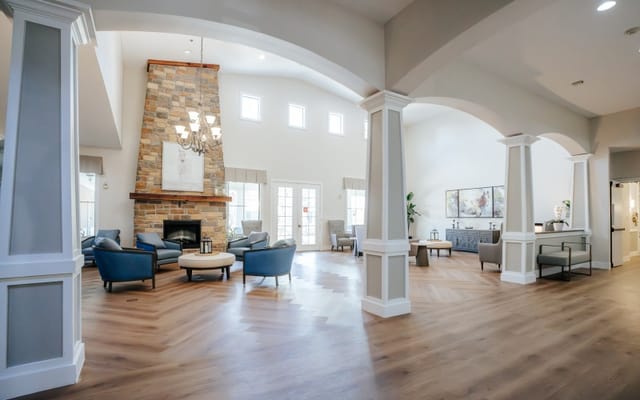Bright common area with comfortable seating and a fireplace