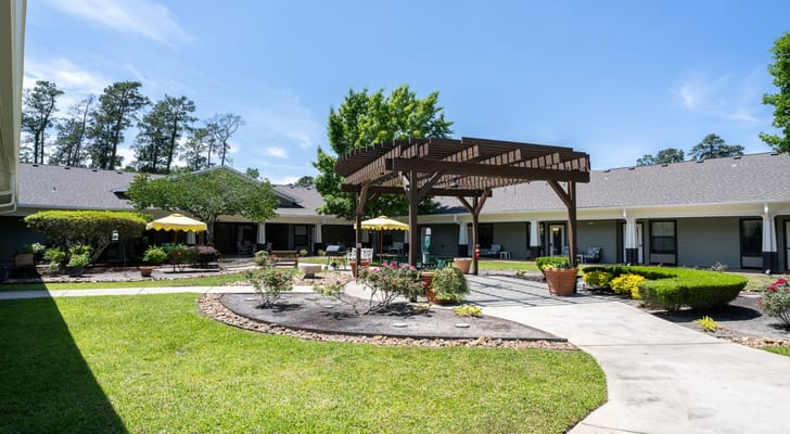 A sunny courtyard with seating and landscaping