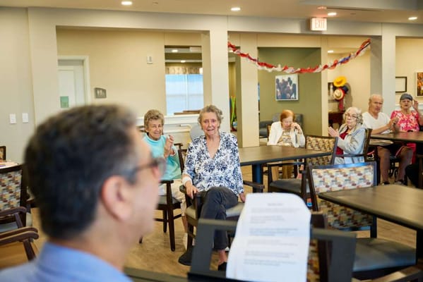 Residents enjoying a performance in a common area