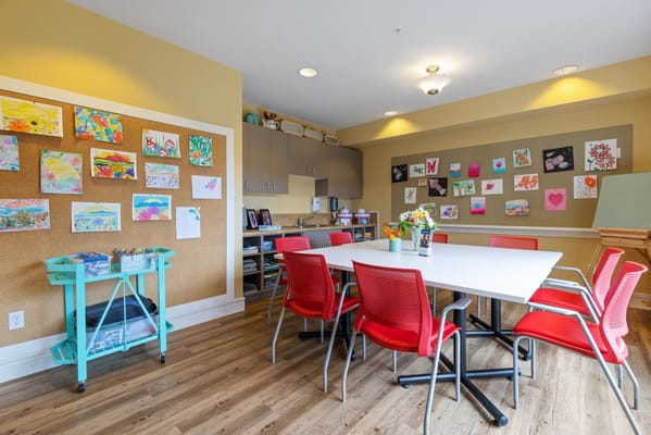Bright activity room with art displayed on walls