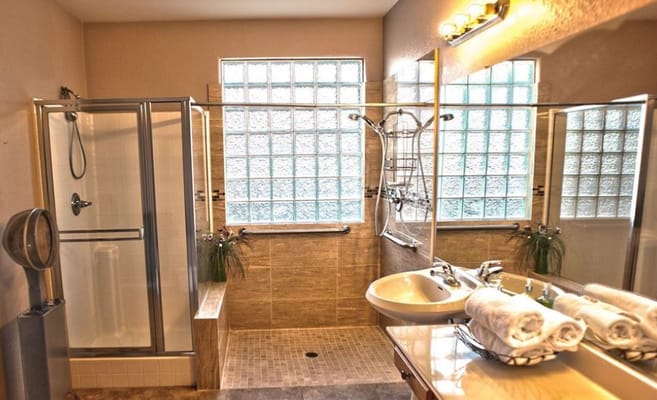Spacious bathroom with glass block windows and modern fixtures