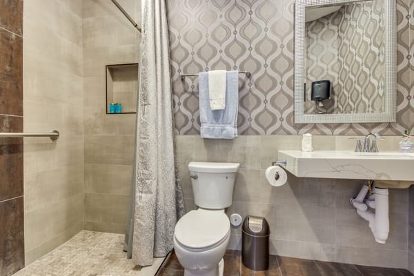 Modern bathroom with shower, sink, and toilet