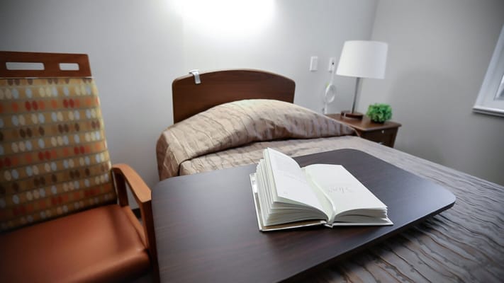 A cozy resident room with a bed and a book
