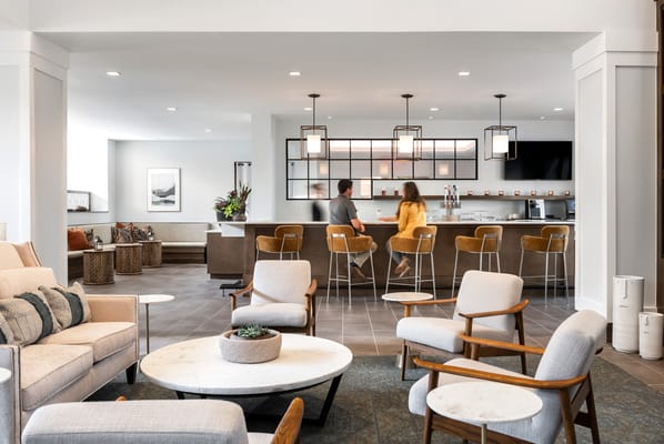 Senior residents enjoying drinks in a bright lounge area