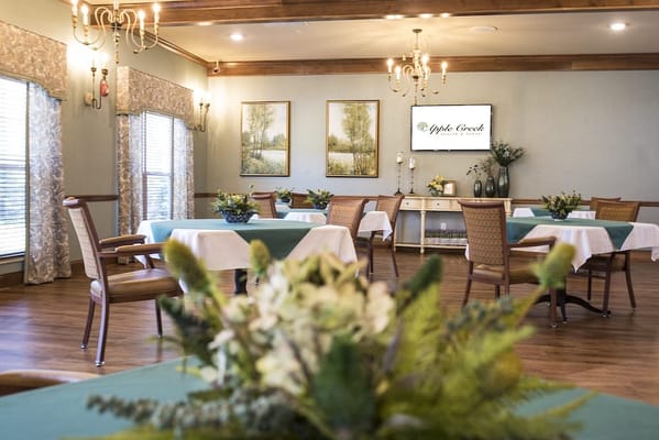 Dining area with tables and decorative flower arrangements