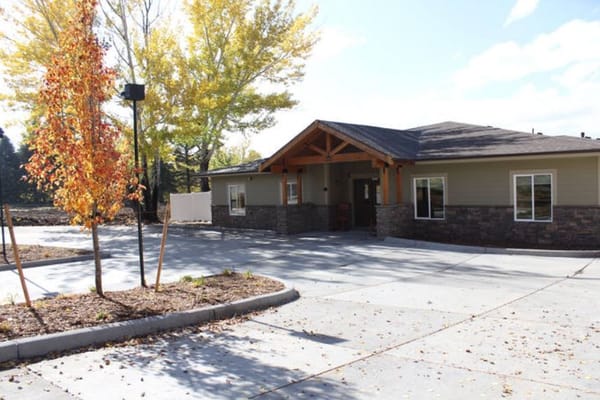 Exterior view of a senior living facility with trees