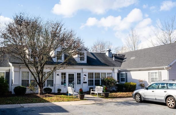 Exterior view of a senior living facility with outdoor space