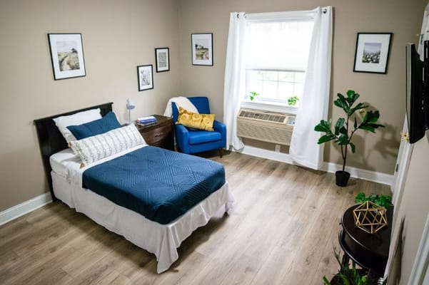 Cozy resident room with a bed and armchair