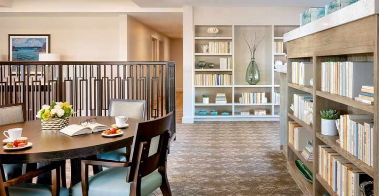 Common area with bookshelves and dining setup