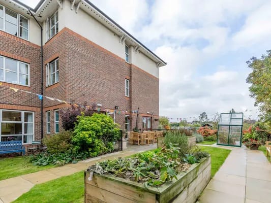 Outdoor view of a senior living facility with a garden