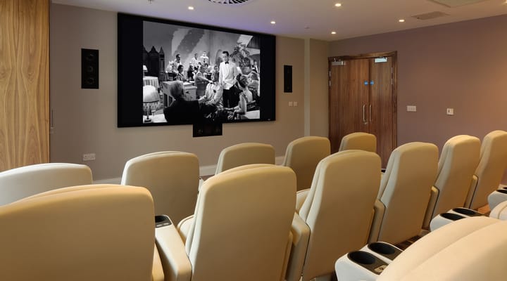 A cozy cinema room with reclined seating