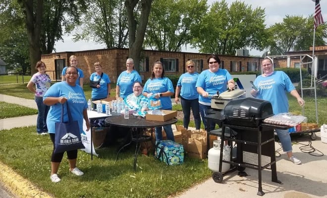 Staff members grilling and socializing outside