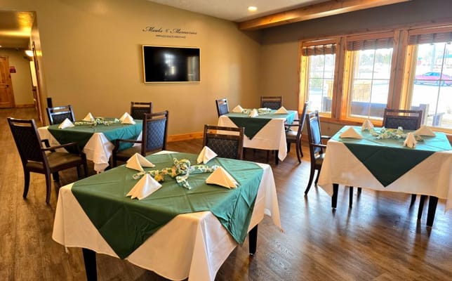 Bright dining room set with green tablecloths and napkins