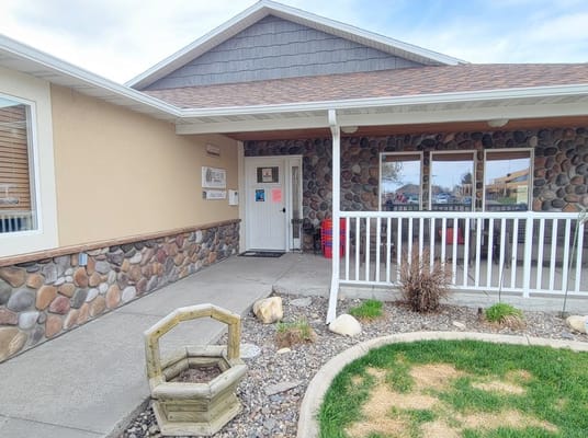 Entrance view of BeeHive Homes facility with garden area