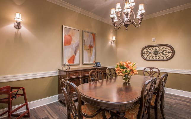 Elegant dining room with a large table and floral centerpiece