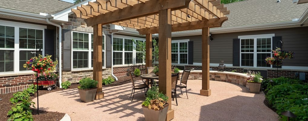 Outdoor seating area with pergola and flowers