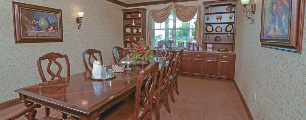 Elegant dining room with a long wooden table and decorations